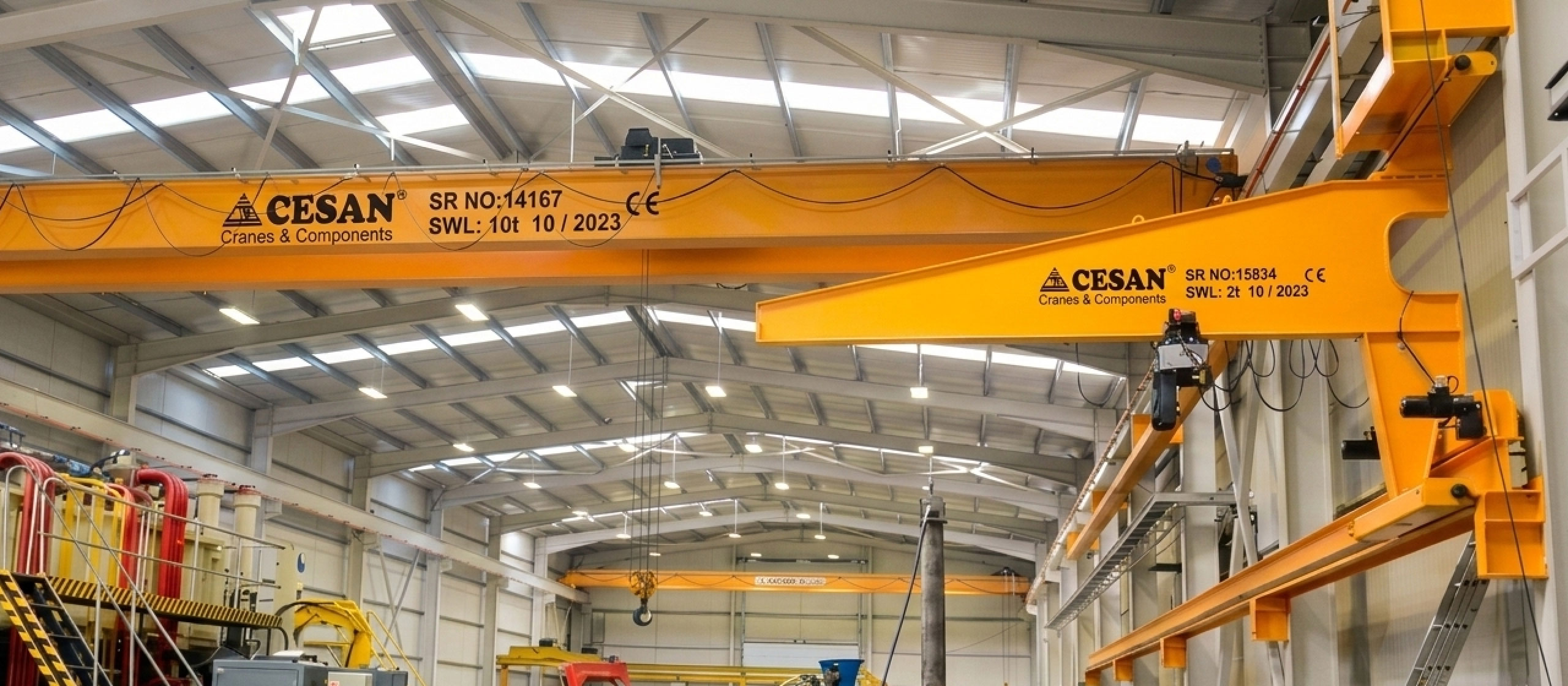 Cesan underhung overhead crane suspended from roof structure in workshop